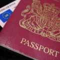 UK Passport and drivers license in close-up against a dark background