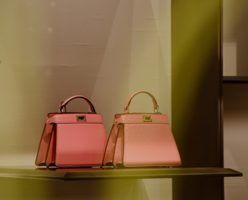 luxury pink handbags on glass shelf