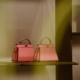 luxury pink handbags on glass shelf